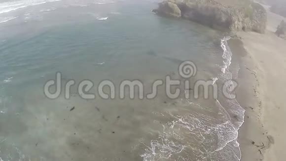 无人机在沙滩和海浪上飞行和盘旋视频的预览图