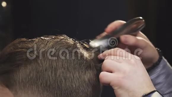 理发师用剪发器剪客户头发的特写镜头视频的预览图