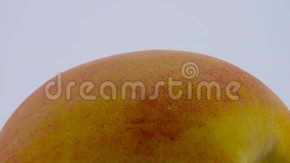 超级接近宏观的一整个桃果在转盘上旋转孤立在白色背景上视频的预览图