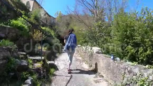 一名单身妇女在法国一个比利牛斯村的小径上散步视频的预览图