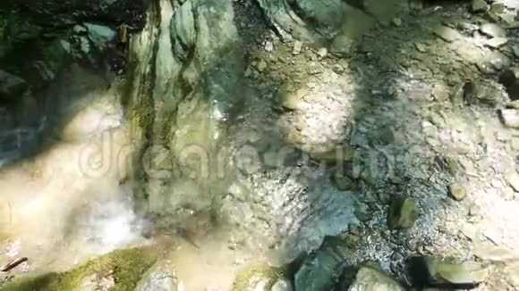 山里的小溪纯净的水流在古老的岩石之间视频的预览图