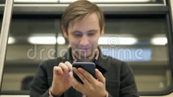 在地铁里用智能手机拉近年轻英俊的学生商人专业上班族视频的预览图