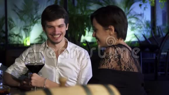 年轻夫妇在酒吧里有个浪漫的约会一起喝酒聊天视频的预览图