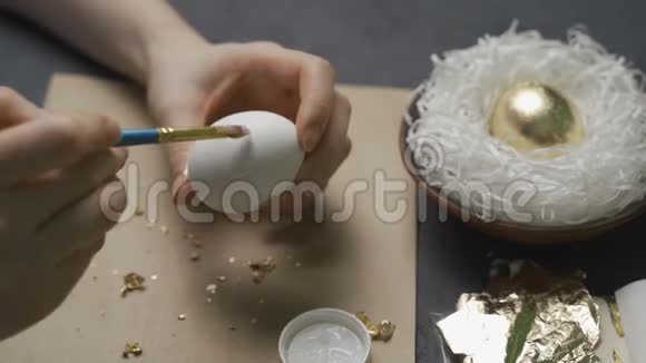 用手和画笔用水彩颜料为复活节彩蛋视频的预览图
