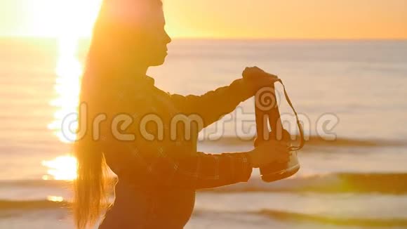 年轻女子在日落时使用虚拟现实眼镜视频的预览图