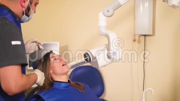 牙医为一个年轻女孩做x光检查以确定病人未来治疗方法视频的预览图