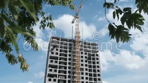 多层在建公寓大楼带有建筑起重机上的木质和天空背景视频的预览图
