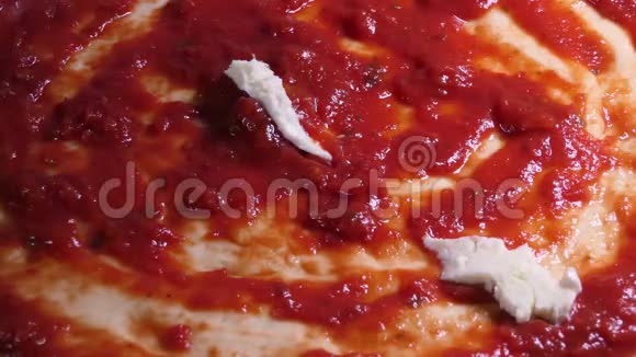 准备披萨饼在披萨上面铺上新鲜的意大利干酪视频的预览图