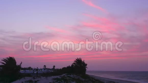海岸带美丽的粉红色日落景观时光流逝视频的预览图