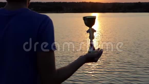 年轻人在湖边的一条小径上放着他的赢家碗视频的预览图