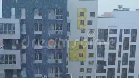 雪花在住宅大厦的新建筑物上飘落的视频动作视频的预览图