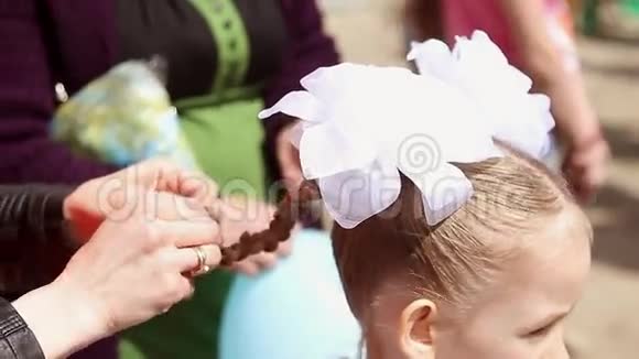 妈妈把女儿的辫子拉直漂亮的小女儿准备过节吧视频的预览图