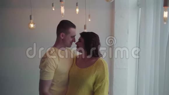 英俊的男人和他怀孕的妻子在家里聚在一起视频的预览图