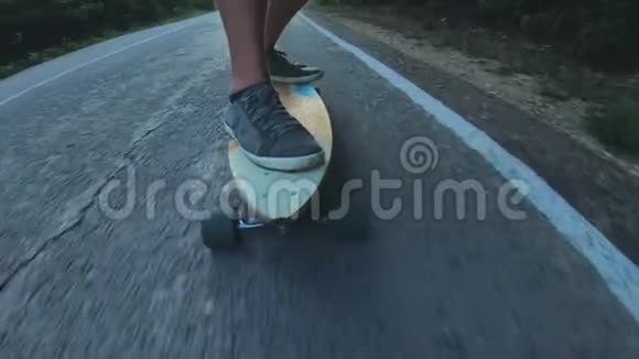 特写滑板少年骑户外一个年轻人骑着长板在高速公路上森林里的米斯蒂路视频的预览图