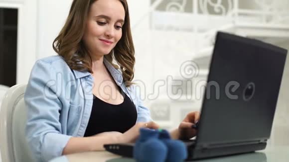 孕妇在网上商店为新生儿购买用手抚摸他的胃交流视频的预览图