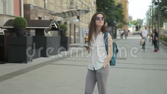这位女游客走在漂亮的街道上环顾四周享受她的旅行视频的预览图