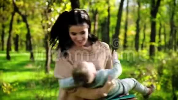 年轻的母亲和她的小男孩在秋天公园玩得很开心视频的预览图
