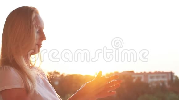 日落时女人把奶油涂在手上慢动作视频的预览图
