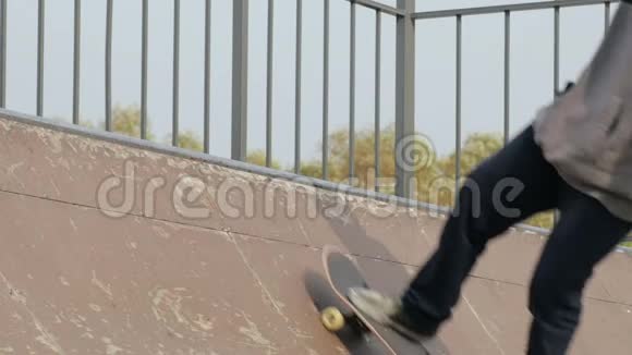 溜冰者在斜坡半径的边缘特写慢镜头做魔术摇滚站立视频的预览图