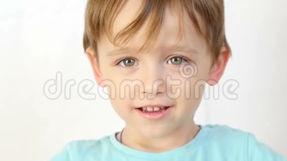 特写的一个孩子看着镜头喜笑颜开男孩表现出快乐和微笑积极的情绪视频的预览图