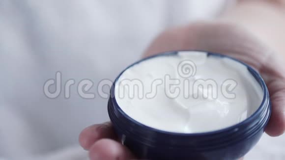白种人女人用食指蘸取化妆霜视频的预览图