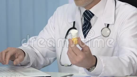 男性治疗师在笔记本电脑电子病历中插入有关药片的数据视频的预览图