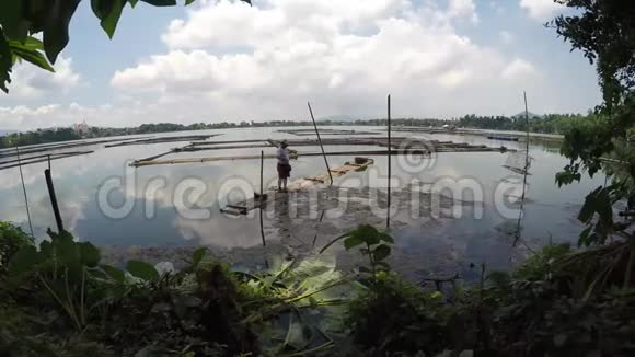 在污染的湖面钓鱼的渔夫跟踪镜头视频的预览图