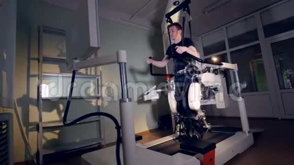 一个年轻人在一个大型的医学外骨骼系统中训练视频的预览图