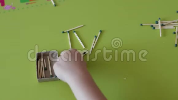 一个小孩在桌子上玩火柴白色背景白种人危险小孩的手特写视频的预览图
