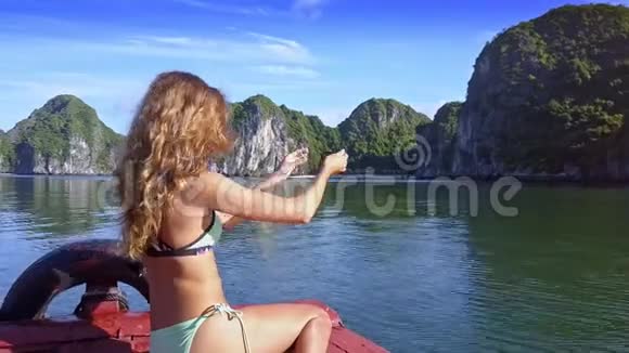 侧景金发女孩在海湾的船上做自拍视频的预览图