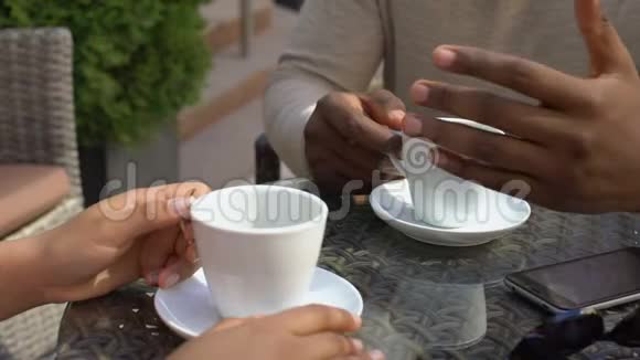 黑人和坐在咖啡馆里的女人交谈同事一起喝咖啡视频的预览图