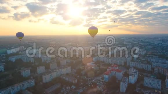 迎着夕阳飞越城市上空的气球晚间飞行冠军赛视频的预览图