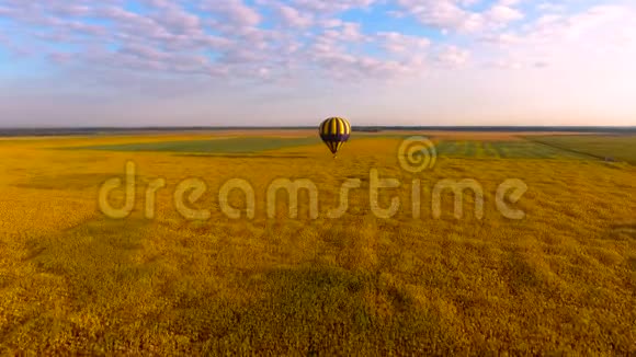 低空飞行的热气球在淡黄的天空中俯瞰蓝天视频的预览图