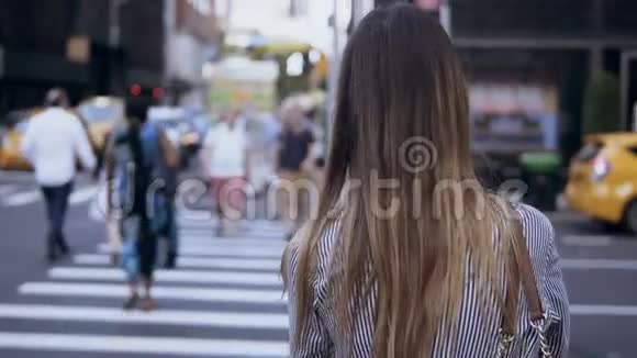 年轻时尚的女性走在市中心女性穿过马路穿过纽约的人群视频的预览图