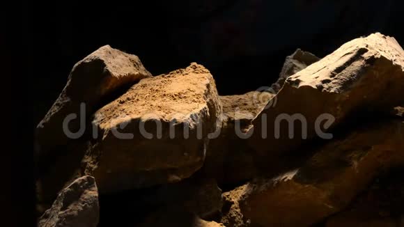 黑色背景上孤立的花岗岩石块堆视频的预览图
