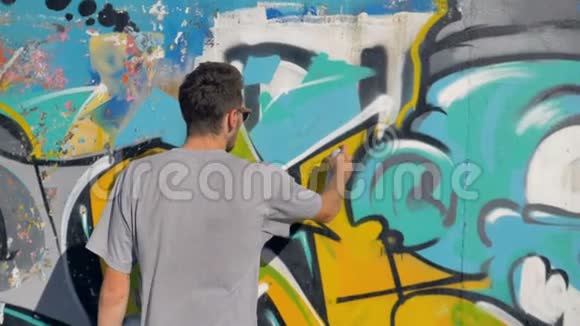 艺术家正在墙上画一个黄色的字母特写视频的预览图