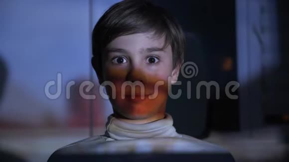 在黑暗中看电视的小男孩视频的预览图