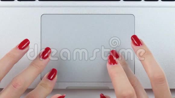 4K镜头女人的手红色指甲使用和点击便携式电脑轨迹板俯视图特写视频的预览图