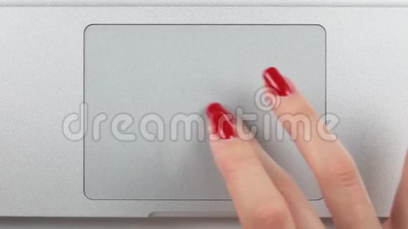 4K镜头女士右手红色指甲使用和点击一个轨迹板俯视图特写视频的预览图
