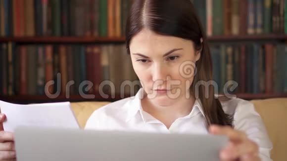 女商人在家用笔记本电脑处理文件家庭办公概念远程自由工作视频的预览图