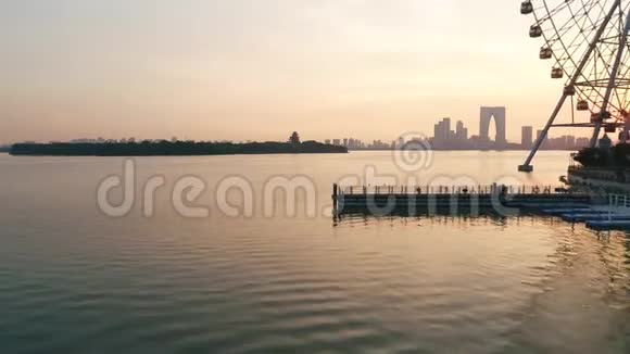 272018年7月中国苏州城市空中无人机飞越金鸡湖水面日落现代建筑视频的预览图