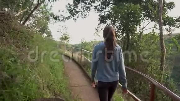 在热带森林公园散步的女人视频的预览图