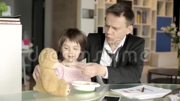 工作的父亲喂养小女儿视频的预览图