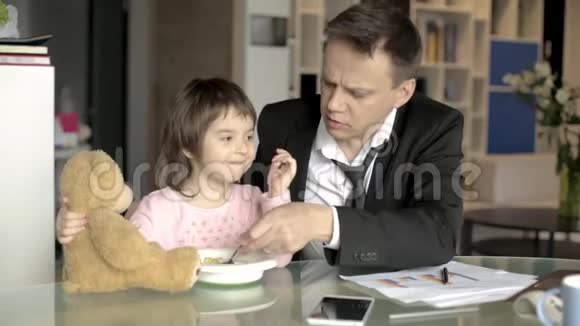 工作的父亲喂养小女儿视频的预览图