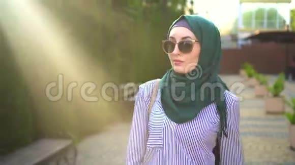 一个穿着头巾的时髦穆斯林女人的肖像太阳照视频的预览图