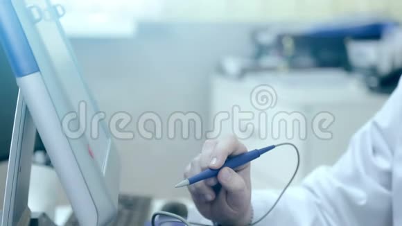 医生手写笔的特写用电脑屏幕检查病人心脏视频的预览图