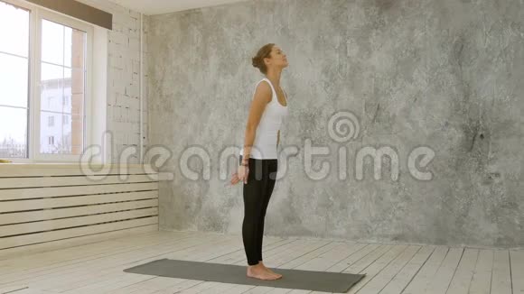 美丽的运动健身女性练习瑜伽体式太阳敬礼姿势视频的预览图