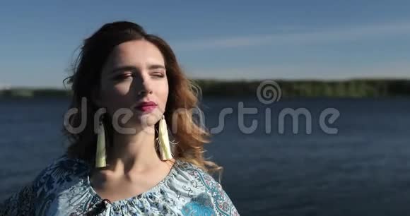 一位留着长发戴着时髦耳环的美女模特在游船上休息视频的预览图