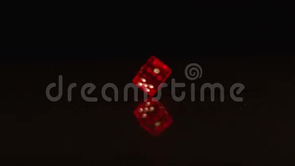 红色塑料骰子旋转黑色背景视频的预览图