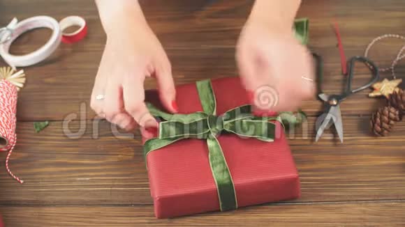 女性手装饰圣诞礼物红色盒子把手举起来视频的预览图